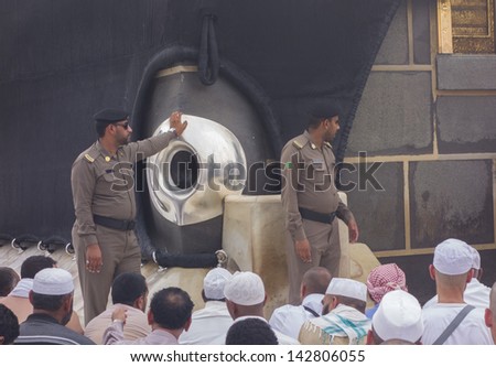 MECCA,S.ARABIA-JUNE 5:Police mosque look after black stones (hajarul aswad) encased in a silver frame Jun 5,2013 in Makkah.Muslims believe the black stone dates back to the time of Adam and Eve. - stock photo