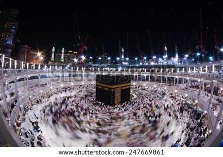 MECCA, SAUDI ARABIA-CIRCA DEC 2014: WIde angle view of Muslim pilgrims circumambulate the Kaaba counter-clockwise at Masjidil Haram in Makkah, Saudi Arabia. - stock photo