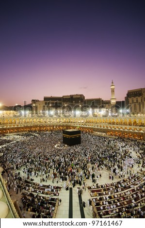 Muslim pilgrims circumambulate the Kaaba after dawn prayer at Masjidil Haram in Makkah, Saudi Arabia. Muslims all around the world face the Kaaba during prayer time. - stock photo