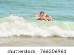 Small photo of Boy in inflatable ring floating on the sea all wet and happy