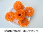Small photo of Indian jalebis arranged in flower shape in white plate isolated white background, top view. favorite pastry item in Kerala, India. Dewali sweet, fried crispy dessert. yellow, brown ,orange jalebis