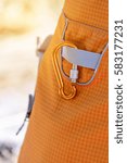 Small photo of Orange color carabiner hang on hiking bag.