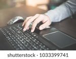 Small photo of Close up business person's hands using computer on wooden table outside the office in weekend. Woman's hands using laptop computer access internet searching information for work outside work place.