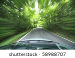 car driving fast into forest