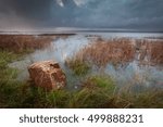 Small photo of The Loughor estuary Storm clouds and a full tide at the Loughor estuary on the Gower peninsula in South Wales