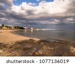 Small photo of Beach with storm clouds a sunset in the Mar Menor, a very touristy place
