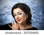 Small photo of Face portrait of Caucasian mature woman with Vedic patterns on frost background