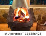 Small photo of A nice oven in a cozy living room with a crackling fire inside