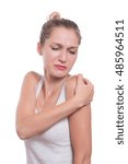 Small photo of Acute pain in a woman shoulder. Female holding hand to spot of shoulder-aches