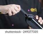 Small photo of closeup of the hands of a young man uncorking a bottle of red wine cutting the closure with an opener - focus on the right forefinger