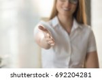 Small photo of Female helping hand extended at camera for handshake, welcoming to cooperation concept, inviting at meeting, medical consultation, job interview, open to cooperation, good first impression, close up