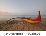 an outrigger canoe sit on the...