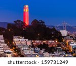 coit tower lit up in red and...