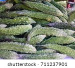 Small photo of Fresh green bitter gourd or bitter melon herb at rural market
