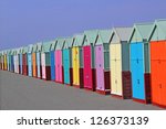 row of colored beach huts with...