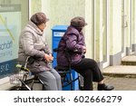 Small photo of Germany, March 14, 2017, Bad Muskau, Older ladies make a break and sit on their walkers