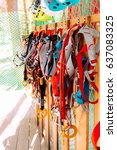 Small photo of climbing equipment - carabiner, red, blue and black rope, on wood wall, outdoor workout