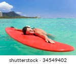 woman with red surfboard in...