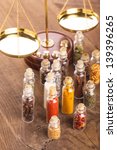 Small photo of Little bottles with spices and scales on the table, vedic cuisine