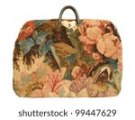 Small photo of An antique carpetbag with a flower pattern isolated against a white background