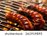 grilling sausages on barbecue...