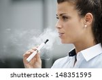 stock-photo-young-female-smoker-smoking-e-cigarette-outdoors-head-and-shoulders-side-view-148351595.jpg