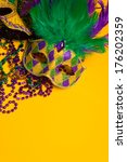 Small photo of A festive, colorful group of mardi gras or carnivale mask on a yellow background. Venetian masks.