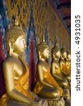 a row of seated buddha statues...