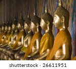 a row of seated buddhas at the...