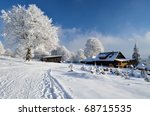 old chalet under snow tree and...