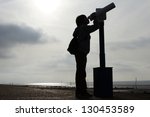 boy looking out of telescope to ...