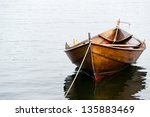 old wooden row boat on water