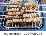 Small photo of Red palm weevil, sago worm (Rhynchophorus ferrugineus) grill on broiler at street food in Thailand