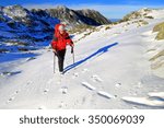 woman hiker ascending snow...