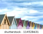 row of coloured beach huts on a ...