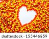 Background of candy corn with heart shape - stock photo