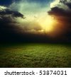 stock photo : Storm dark clouds over field with grass