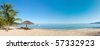 صور شواطىء وبحار  Stock-photo-tropical-beach-panorama-with-deckchairs-umbrellas-boats-and-palm-tree-57332923