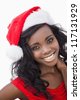 Woman wearing red dress and Santa Claus hat while smiling - stock photo