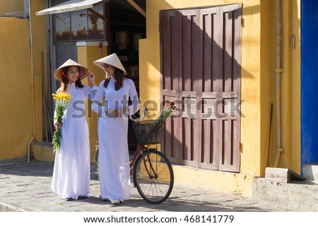 Beautiful woman with Vietnam culture traditional dress, Ao dai is famous traditional costume , vintage style, Hoi an Vietnam
