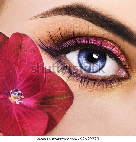 Woman beautiful eye with pink flower