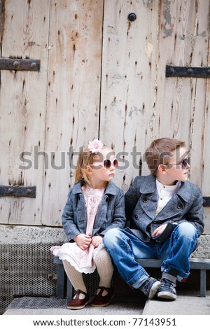 Brother and sister outdoors in city on beautiful spring day
