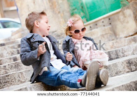 Brother and sister outdoors in city on beautiful spring day