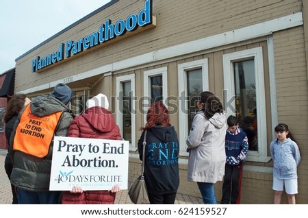 Planned Parenthood, Ferndale, Michigan, USA - March 24, 2017: Planned Parenthood building with pro-life volunteers praying to end abortion, March 24, 2017, Ferndale, Michigan