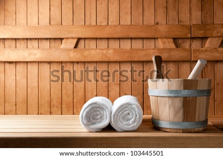 Detail of bucket and white towels in a sauna