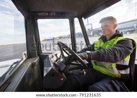 Worker Driving Towing Truck On Runway