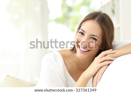 Beauty woman with white perfect smile looking at camera at home