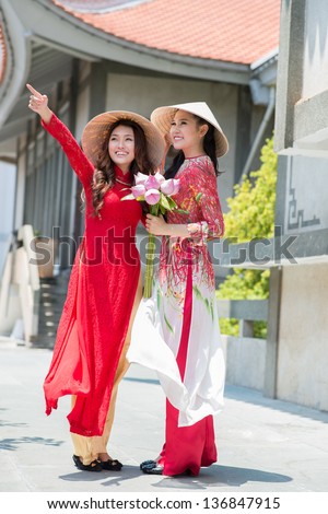 Vertical image of two girls wearing in national clothing outdoors