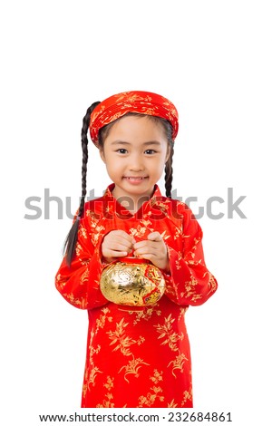 Cute little girl wearing ao dai dress, holding golder lantern