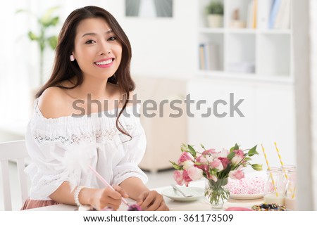 Beautiful Asian woman planning menu for buffet dinner